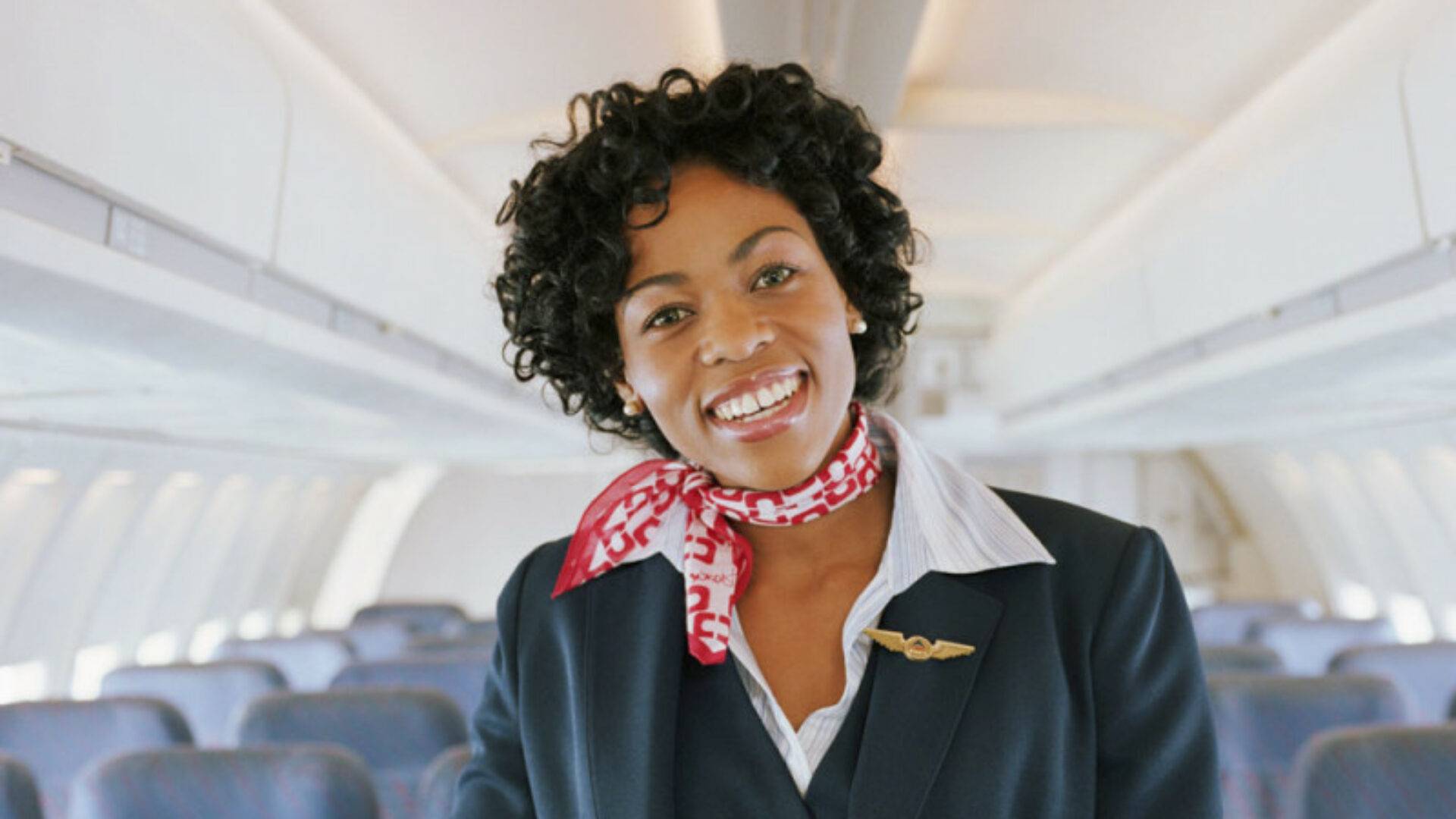 flight attendant smiling on plane