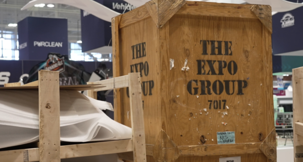 wooden pallet box that has The Expo Group stamp on it