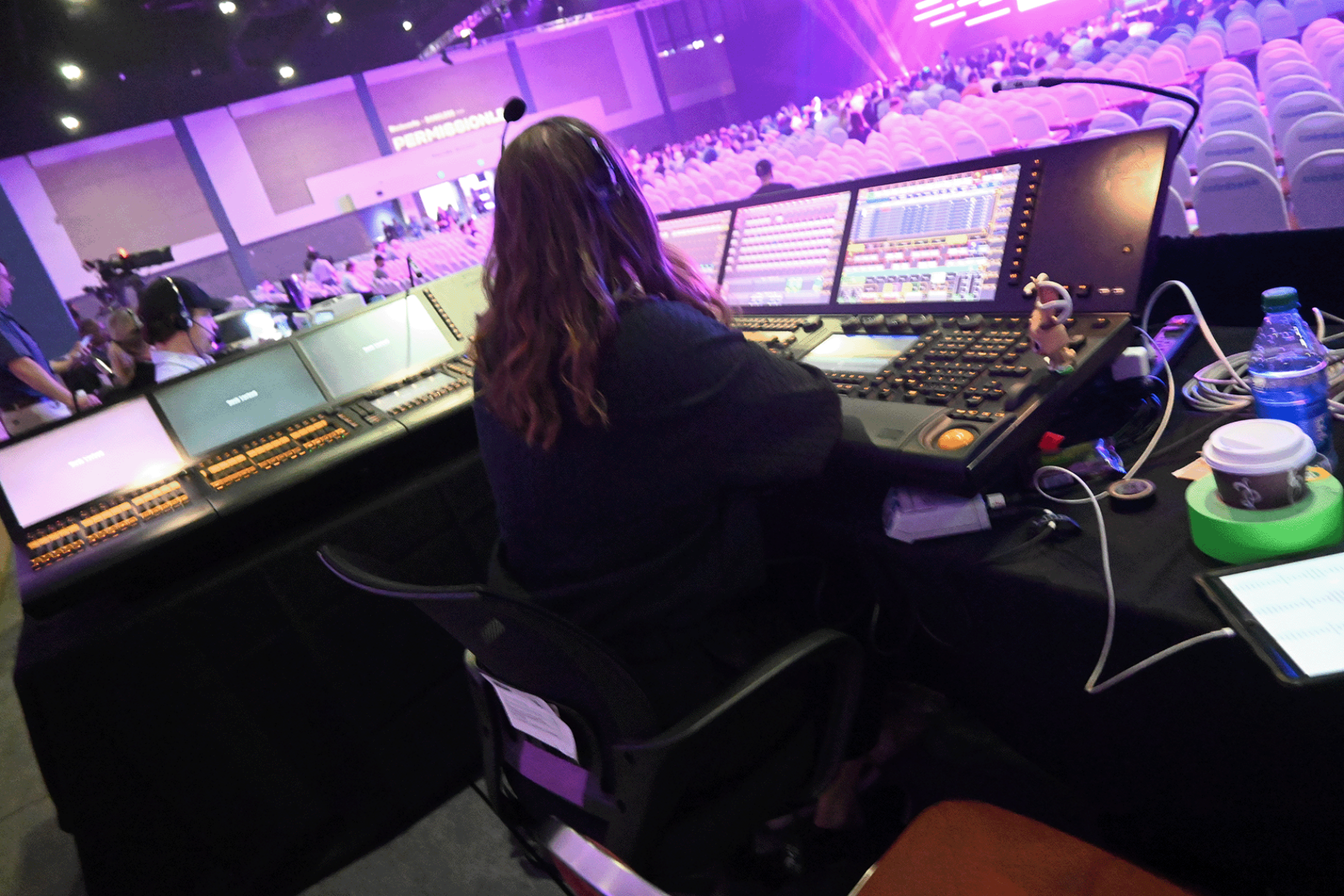 woman sitting in sound booth at event