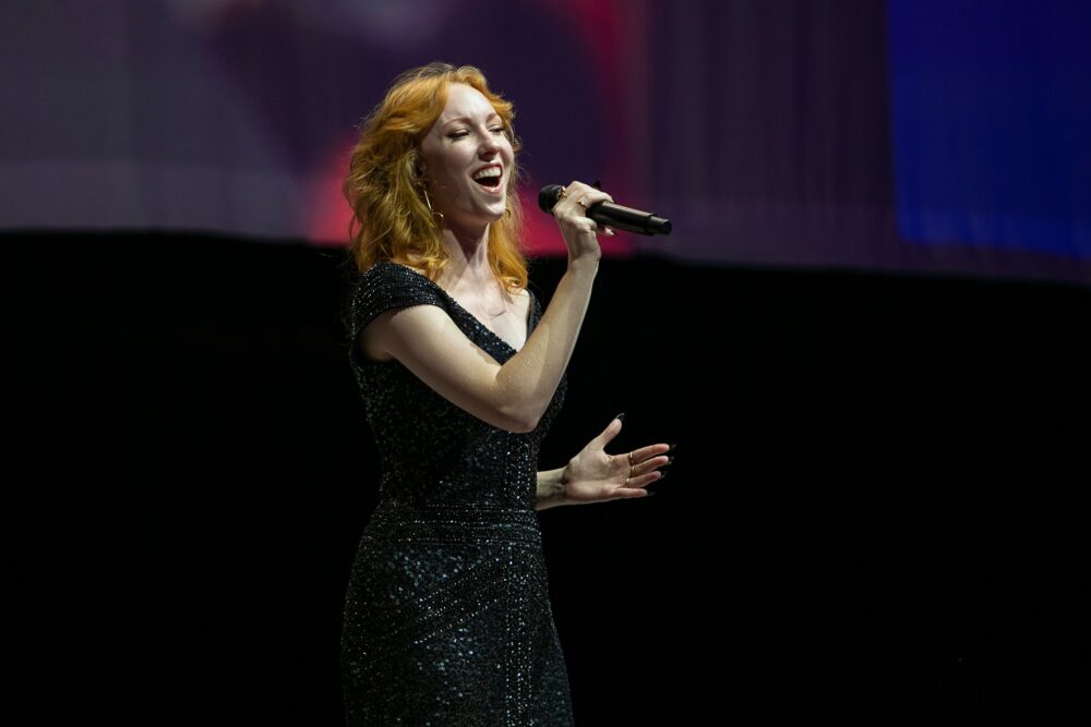 woman singing on stage at University of Florida Campaign Celebration Event